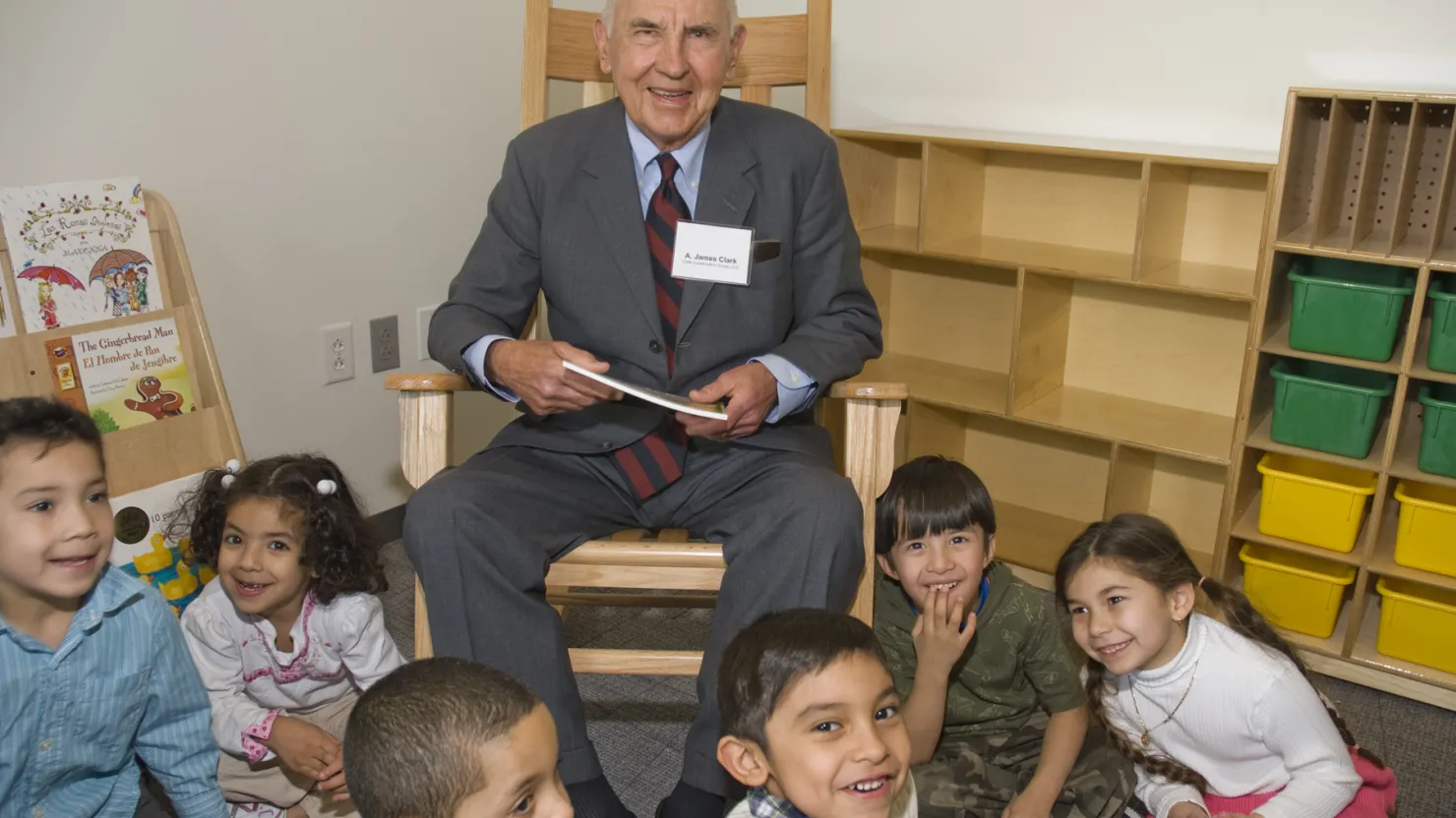 Mr. Clark smiling with a group of children.