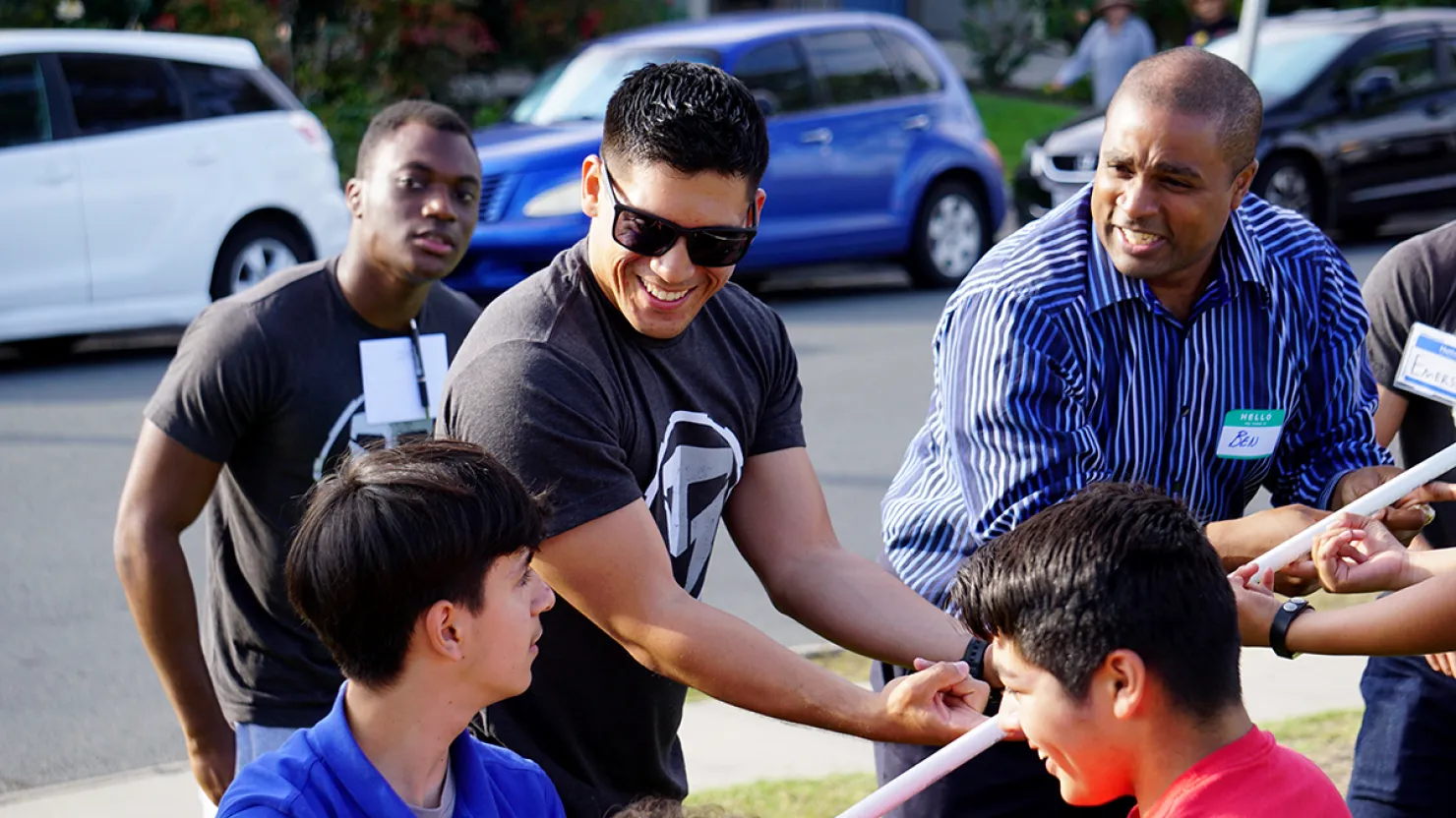 A group of young men doing a team building activity together.