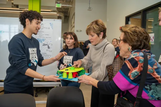 Two Clark Scholars as they explain their prototype for a design challenge to members of the Clark Leadership team.