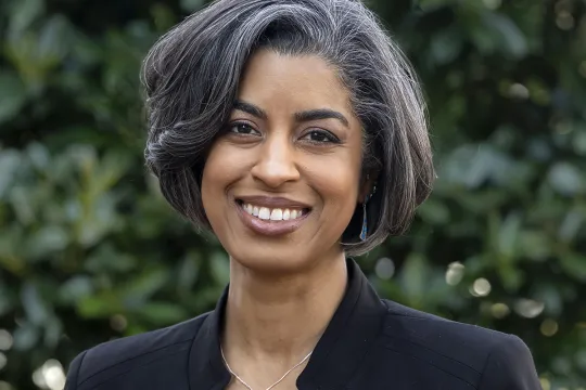 A professional headshot of Ryan Palmer. She has chin-length hair and wears a black blazer.