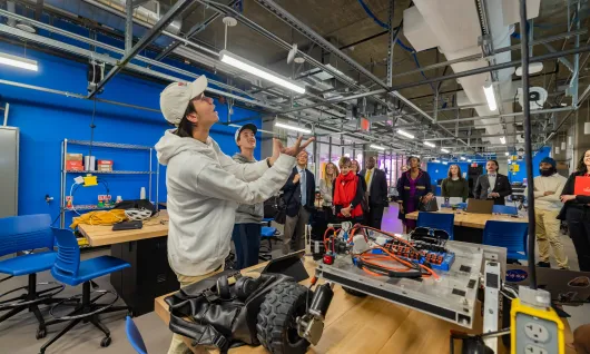 University of Maryland students give a tour of the E.A. Fernandez IDEA lab while Clark Foundation team looks on.