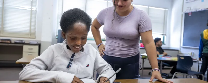 Two high school students work on a project in the classroom.