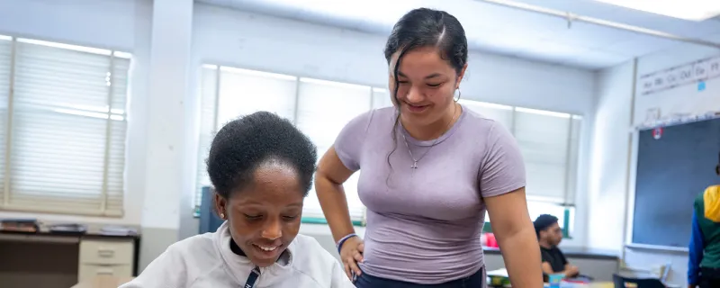 Two high school students work on a project in the classroom. 